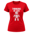 Red women’s Thinking of You graphic tee with white distressed typography and pinned voodoo doll illustration