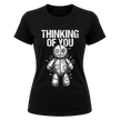 Black women’s dark humor Thinking of You graphic T shirt featuring distressed white voodoo doll artwork