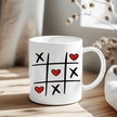 Tic Tac Toe Hearts mug with black grid, X marks, and red heart O's on white ceramic