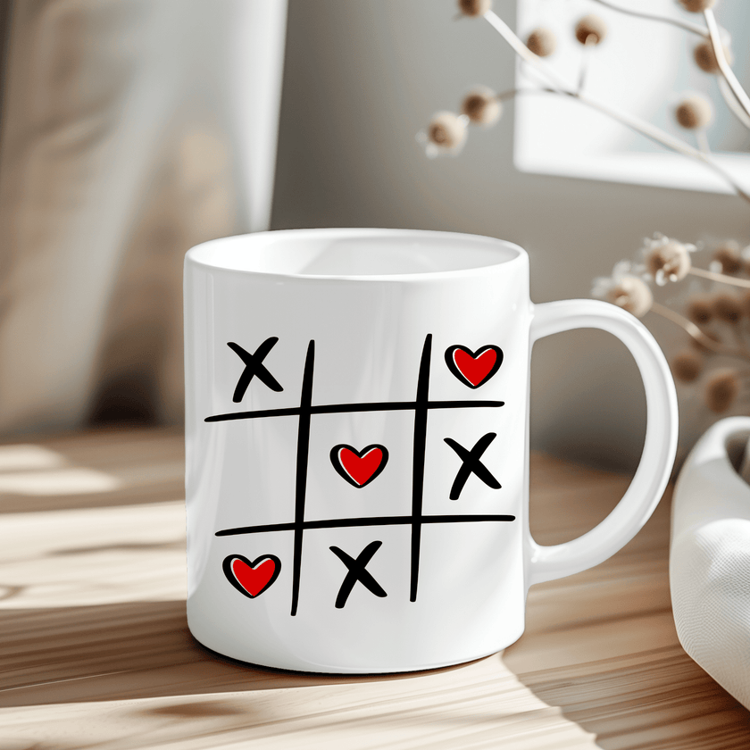 Tic Tac Toe Hearts mug with black grid, X marks, and red heart O's on white ceramic