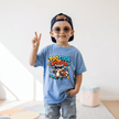 Carolina blue kids T shirt with a bright Too Cool for School raccoon graphic featuring sunglasses, stars, music notes and a backpack.