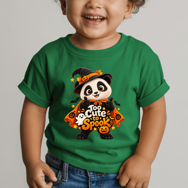 Child wearing a green Too Cute to Spook Panda Halloween youth T shirt featuring a witch panda, pumpkins, ghost and bats