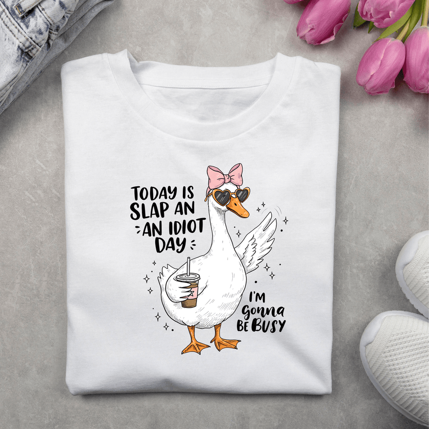 Funny women’s T-shirt with a cute illustrated duck holding a drink, wearing heart-shaped sunglasses and a bow