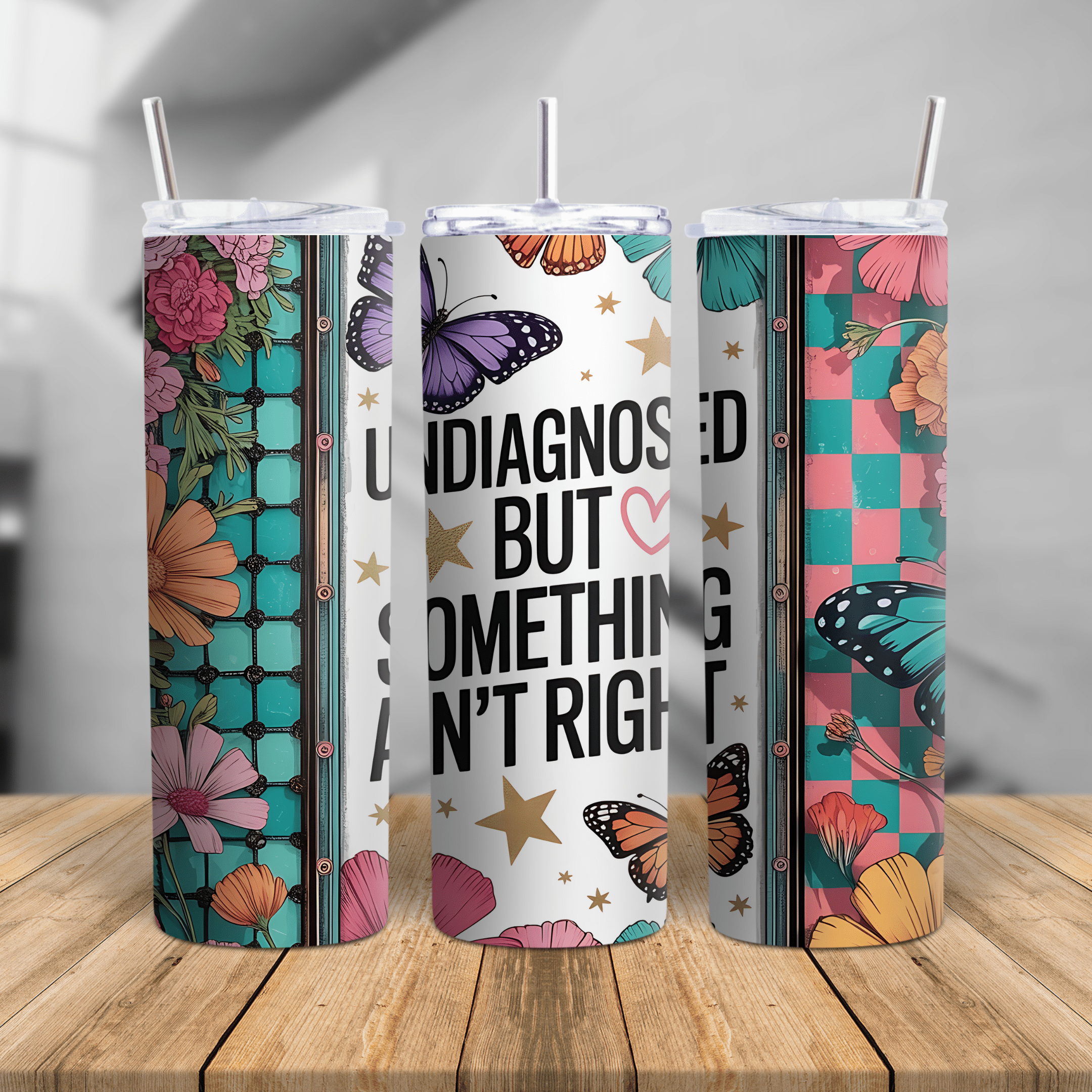 Skinny tumbler with “Undiagnosed But Something Ain’t Right” quote, colorful butterflies, florals, and seamless cup design.