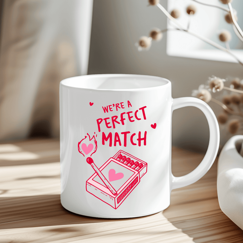 We're a Perfect Match mug with red matchstick heart design on white ceramic