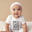 Smiling baby wearing funny World’s Cutest Alarm Clock infant bodysuit in soft white cotton fabric