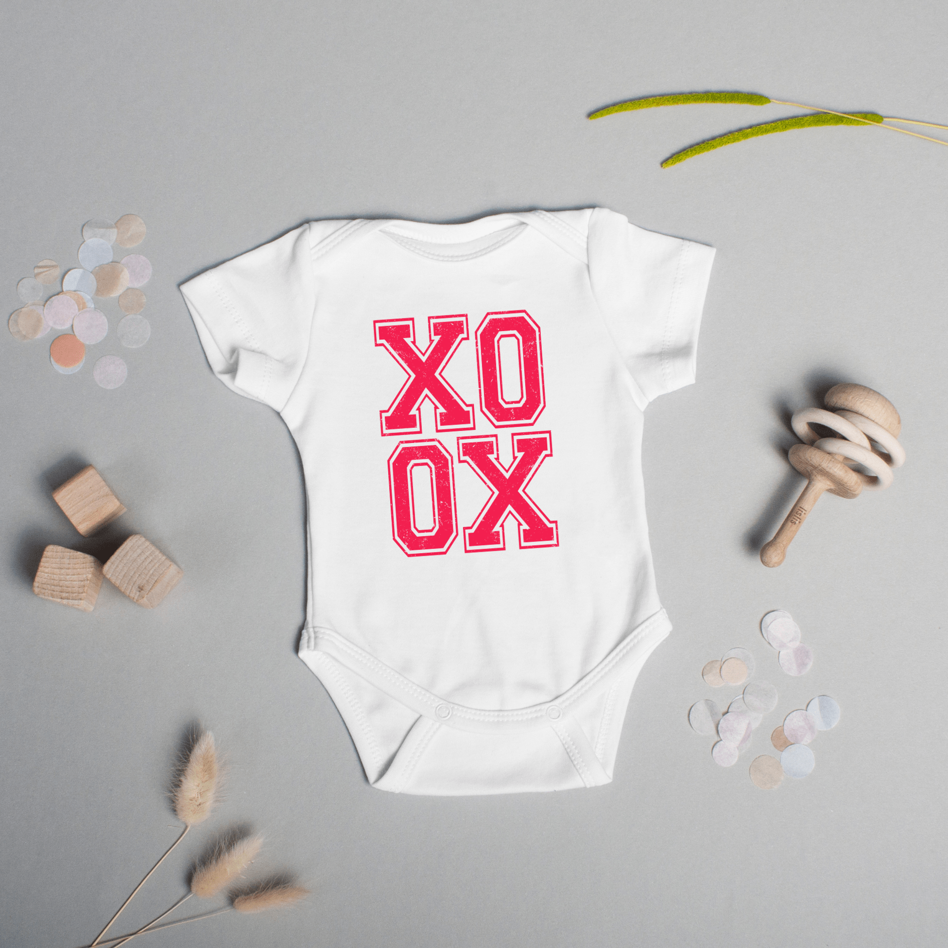 Front view of infant onesie showing centered pink XO XO text