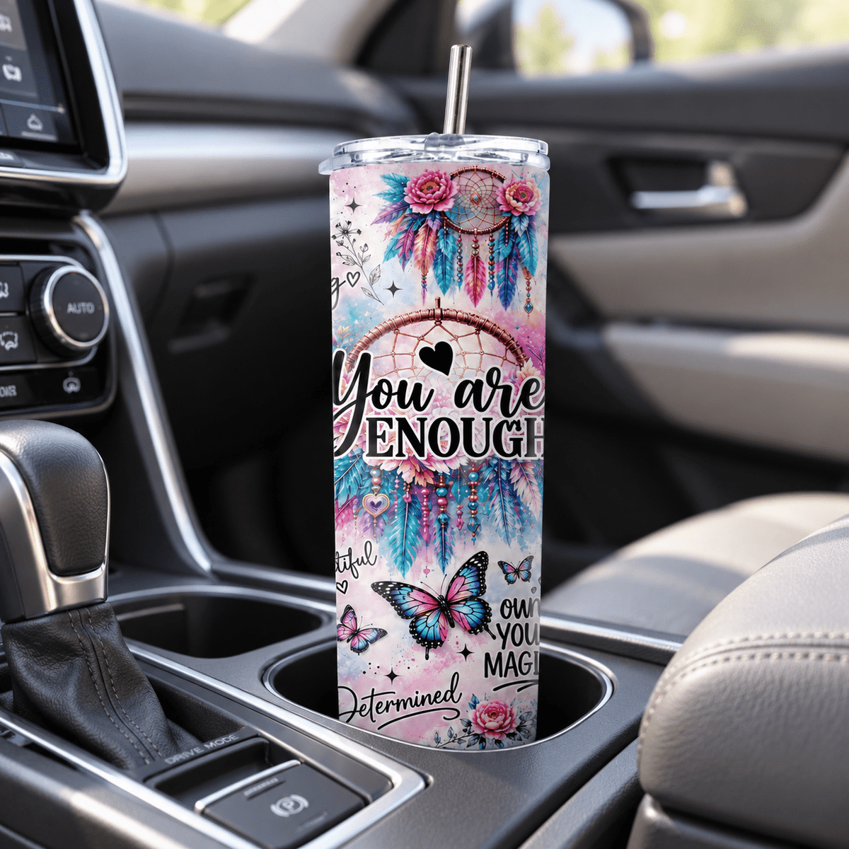 You Are Enough slim travel tumbler sitting in a vehicle cup holder with butterfly, floral and motivational affirmation design