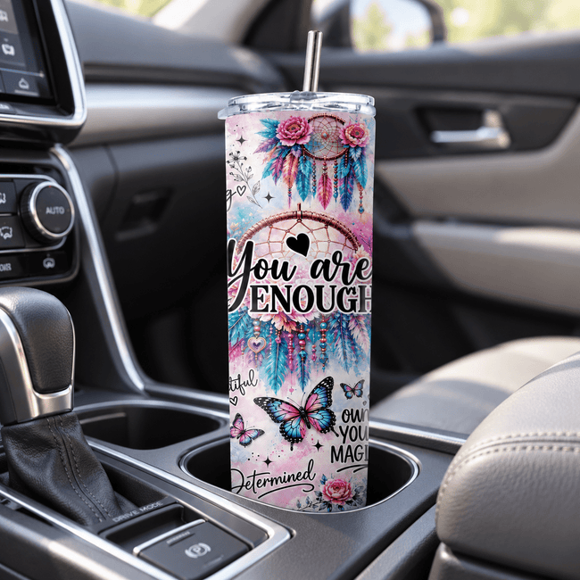You Are Enough slim travel tumbler sitting in a vehicle cup holder with butterfly, floral and motivational affirmation design
