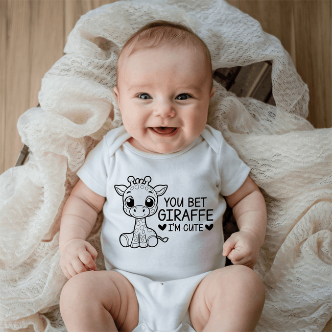 White baby onesie featuring You Bet Giraffe I’m Cute design with adorable giraffe illustration and playful quote